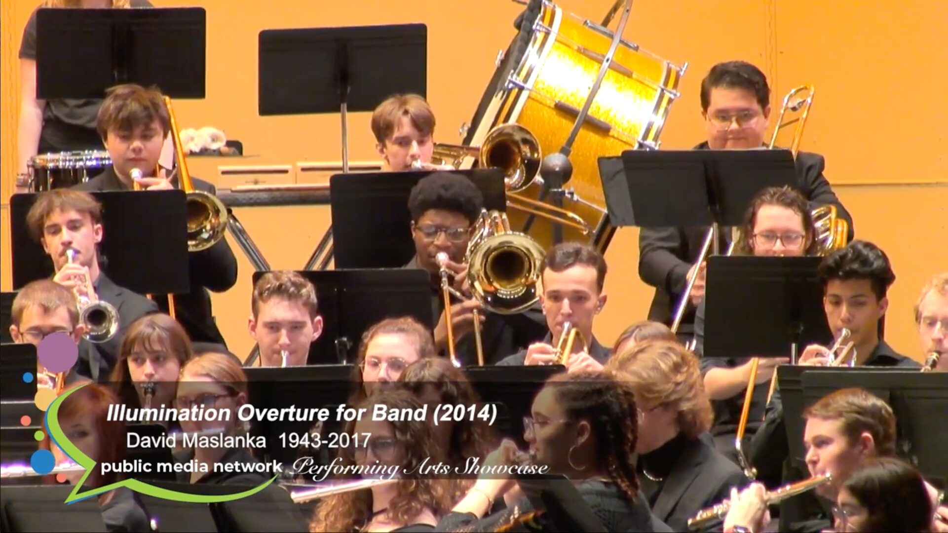 A portion of the WMU band, showing students wearing black and playing various instruments on stage.