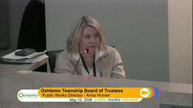 Staff seated at dias present to the board of directors